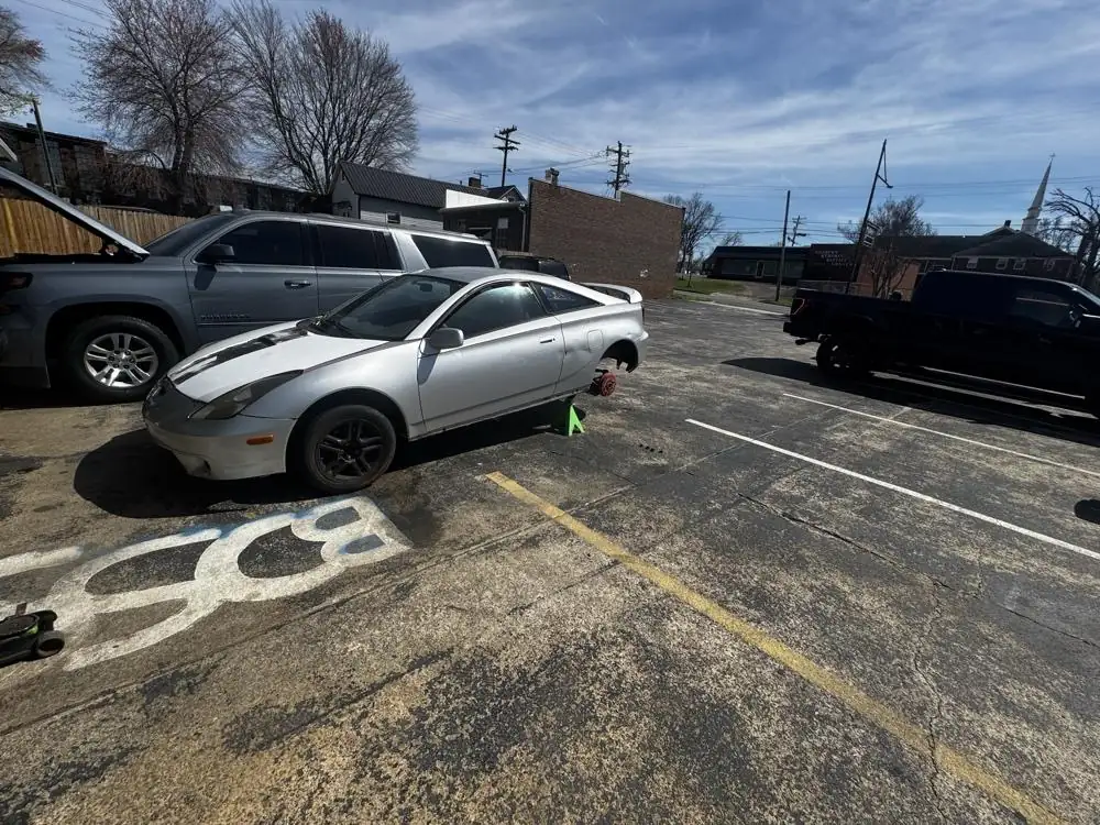 Toyota Celica up on the jack in the lot